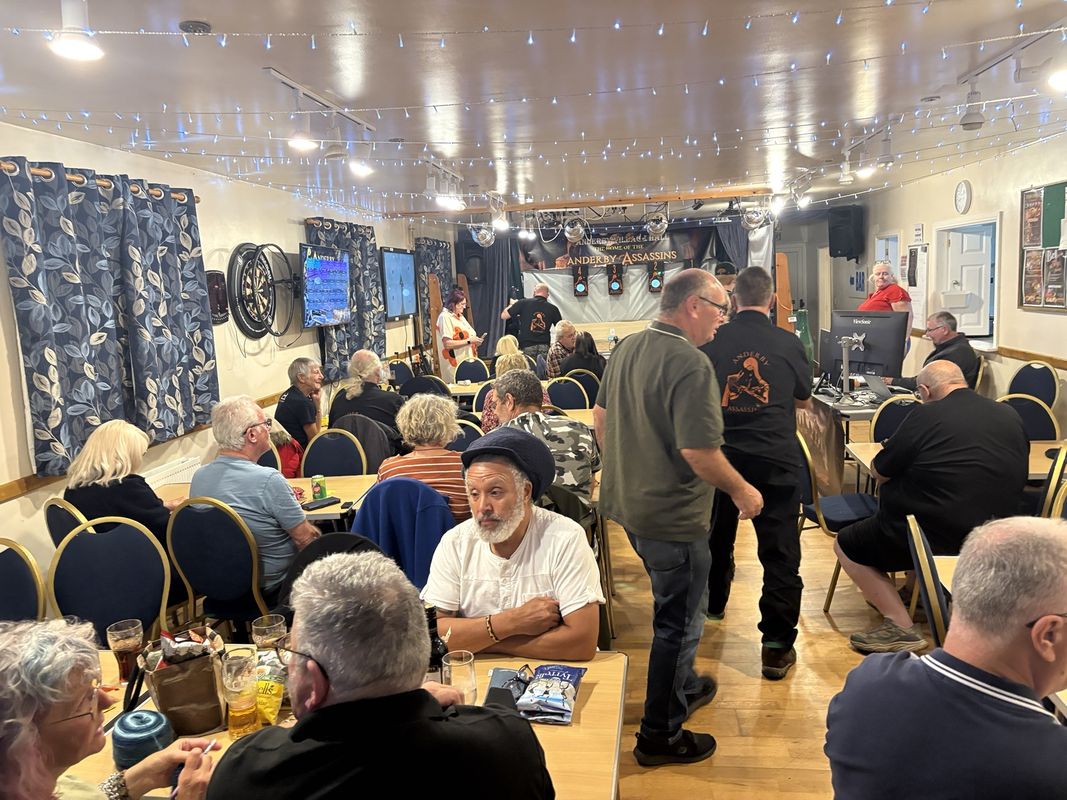 Competitors and spectators at a bell target shooting club evening